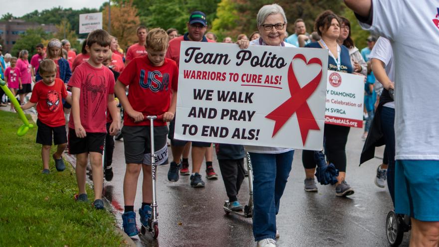 Walk to Defeat ALS participant carrying a sign that reads Team Polito