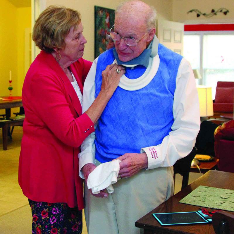 woman helping man with shirt